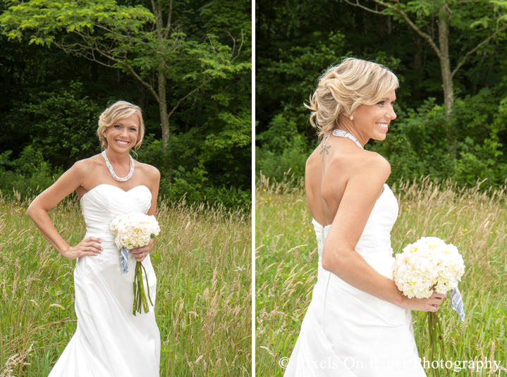 Bride in wedding dress and boots in field at outdoor country mountain wedding at big red barn in west jefferson nc photo