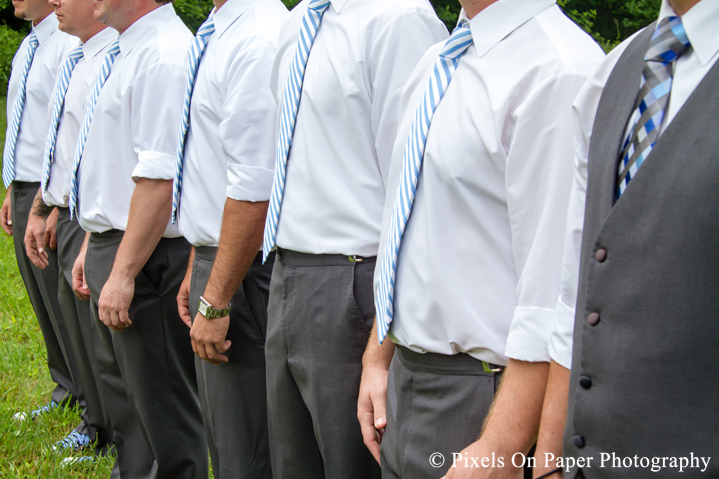 Groom and groomsmen in blue and chuck taylors at outdoor country mountain wedding at big red barn in west jefferson nc photo