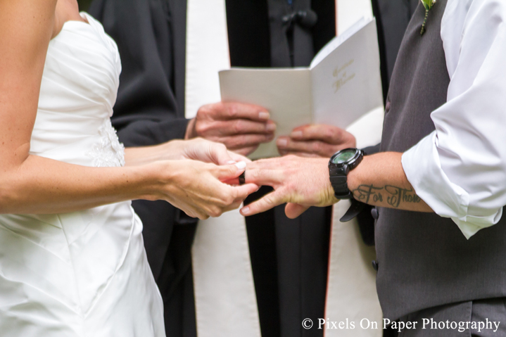 Bride and groom exchange rings at outdoor country mountain wedding at big red barn in west jefferson nc photo