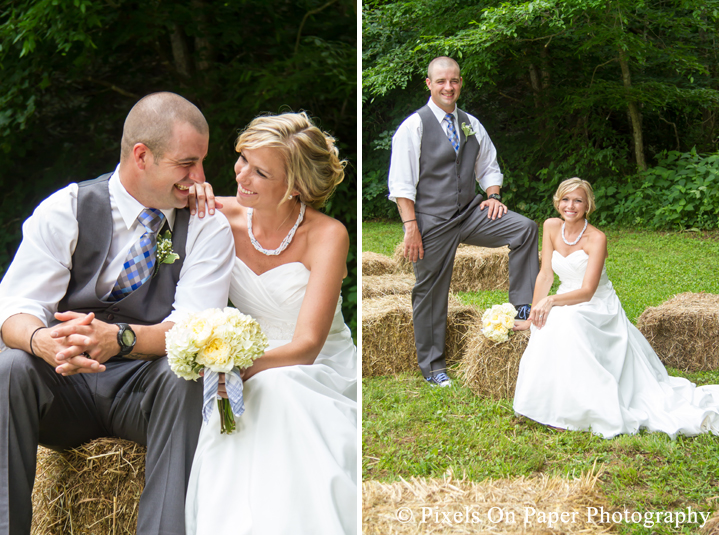 Bride and groom on hay bails for wedding photos at outdoor country mountain wedding at big red barn in west jefferson nc photo