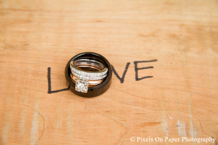 Bride and groom wedding rings at outdoor country mountain wedding at big red barn in west jefferson nc photo