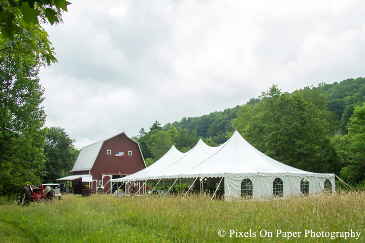Tent in field at outdoor country mountain wedding at big red barn in west jefferson nc photo