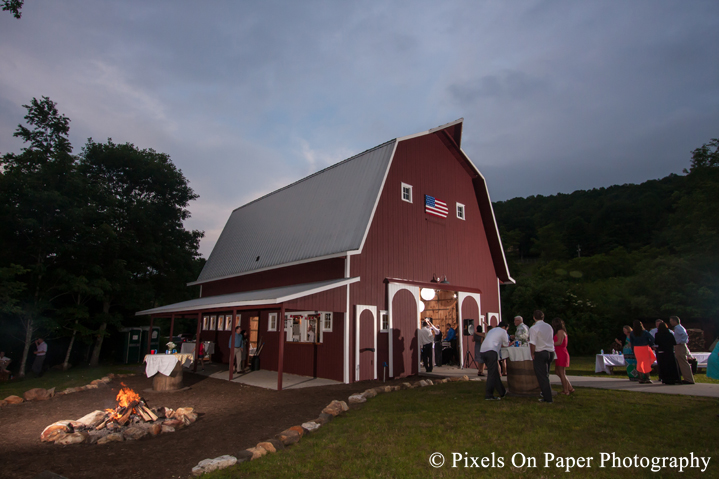 Night photo of barn and fire pit at outdoor country mountain wedding at big red barn in west jefferson nc photo