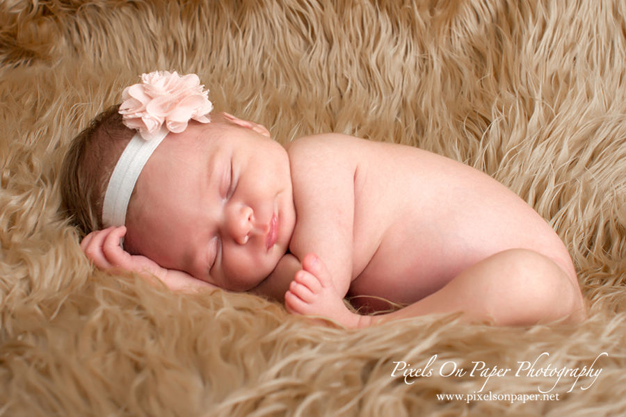 Newborn Baby Portrait. Baby comfy pose during her portrait session with Pixels On Paper Photo