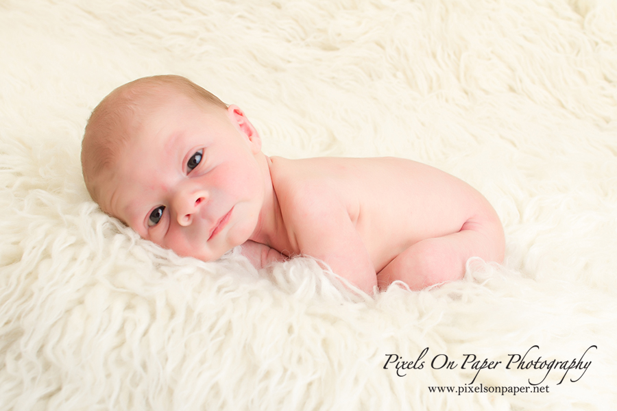 Newborn Baby Portrait Photography by Pixels On Paper Photographers. Baby Liam with eyes open during his newborn session photo.