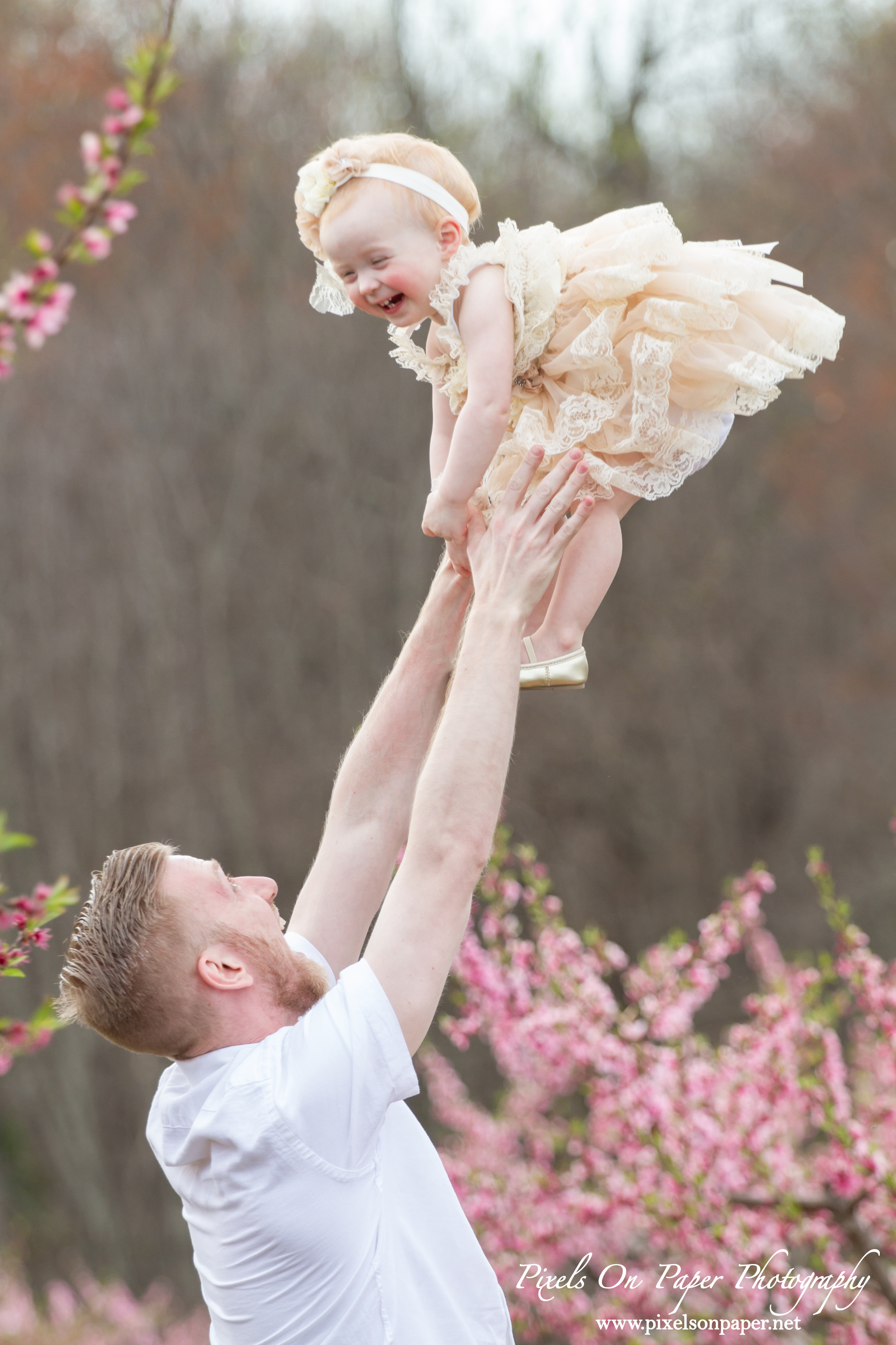 Arnold family outdoor spring peach orchard photos by Pixels On Paper Portrait Photographers photo