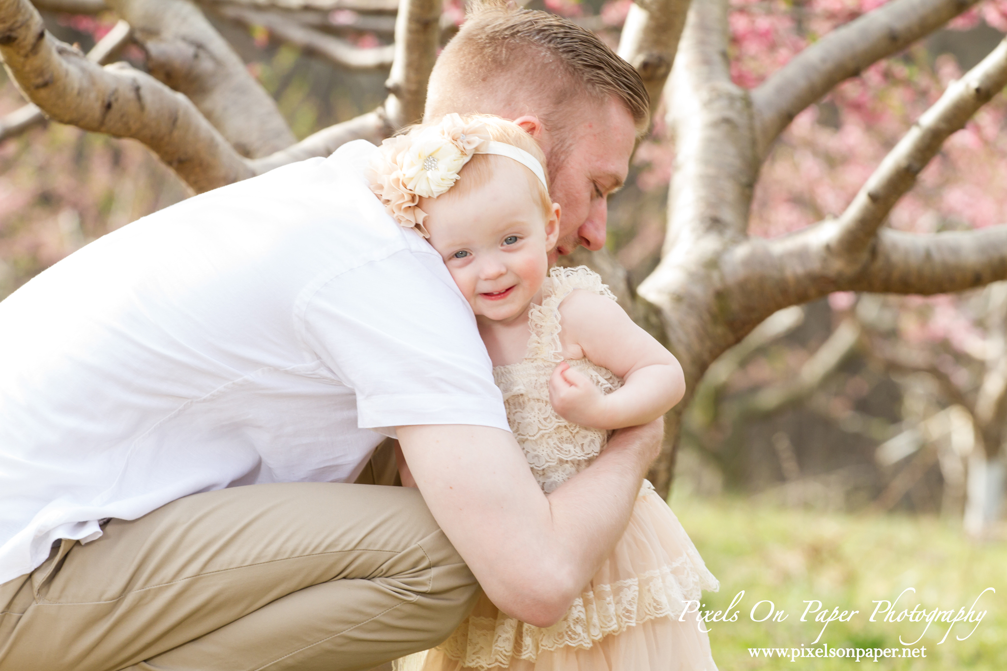 Arnold family outdoor spring peach orchard photos by Pixels On Paper Portrait Photographers photo