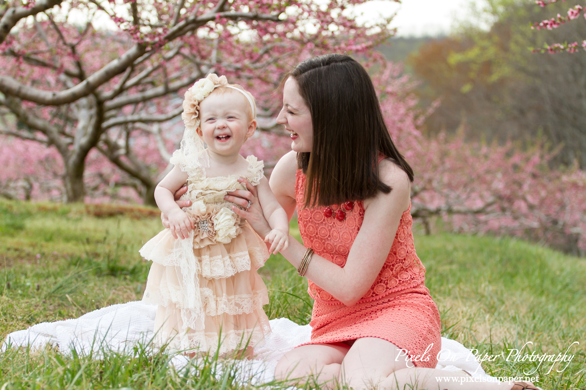 Arnold family outdoor spring peach orchard photos by Pixels On Paper Portrait Photographers photo