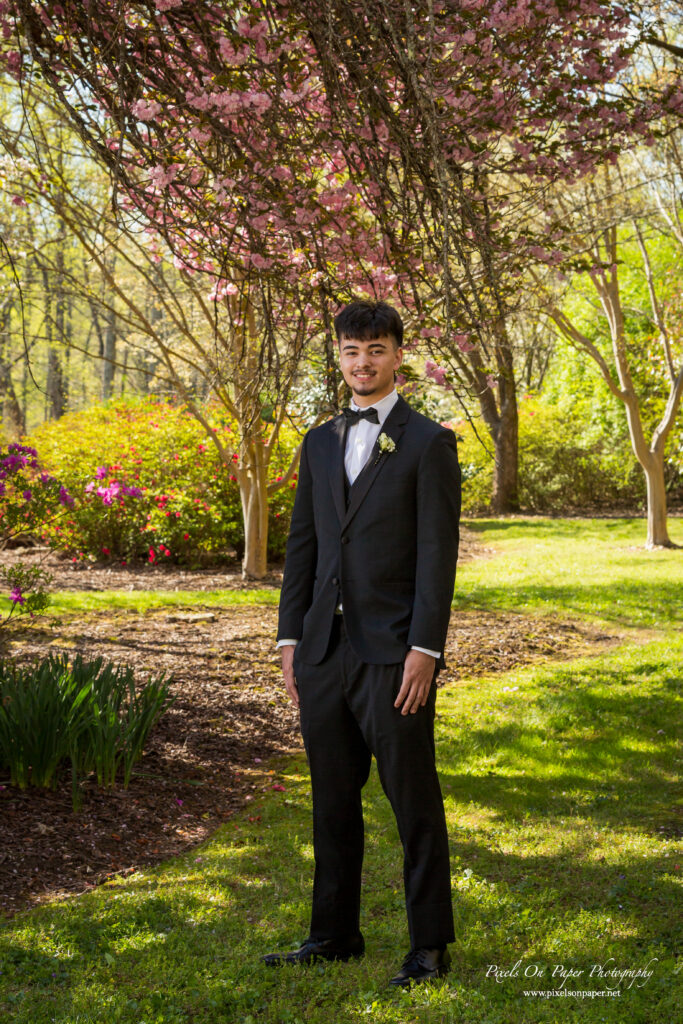 Valek dressed in a sharp prom suit during a professional Wilkes Central High School prom photography session.