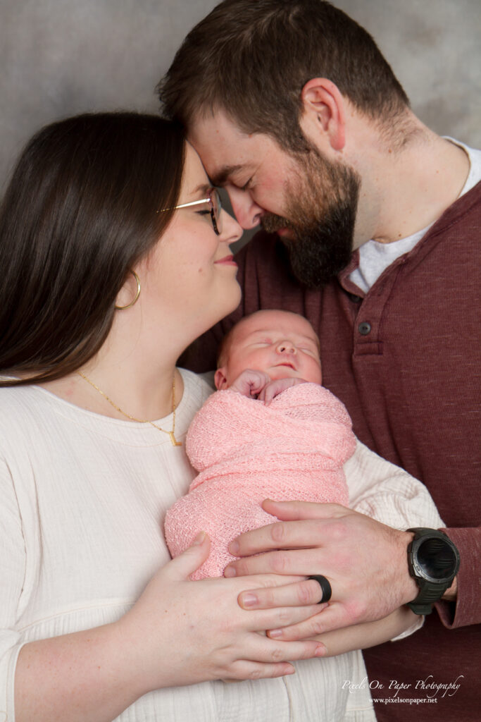 New parents Preston and Maddie holding baby Lucy during her Wilkesboro NC newborn photo session.