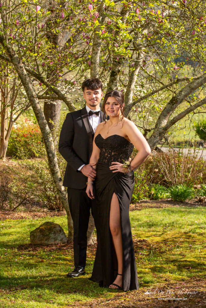Valek and Sailym pose together at Wilkes Central High School prom in a formal outdoor portrait by Pixels On Paper Photography.