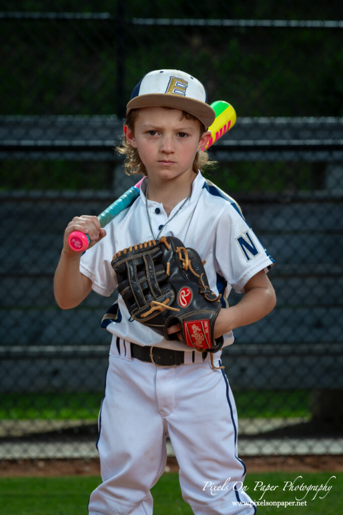 Portrait of NWNC Elite 8U baseball player smiling in uniform holding glove